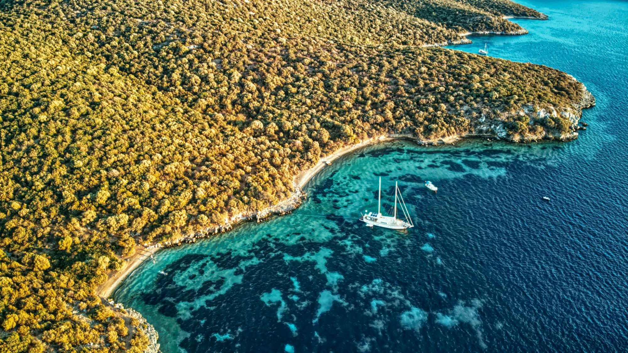 A stunning aerial view of Bodrum's coastline with serene waters and sailboats, perfect for travel enthusiasts.