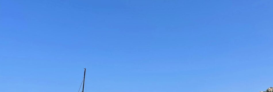 Explore the stunning seascape of La Maddalena, Sardinia with rocky cliffs and tranquil blue waters.